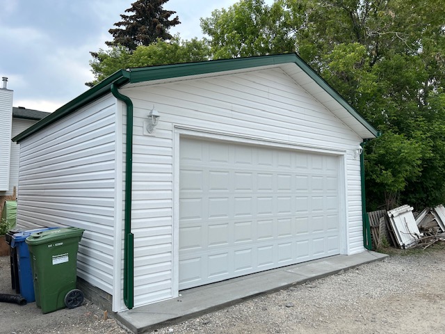 White garage with green roof in Capitol Hill Calgary