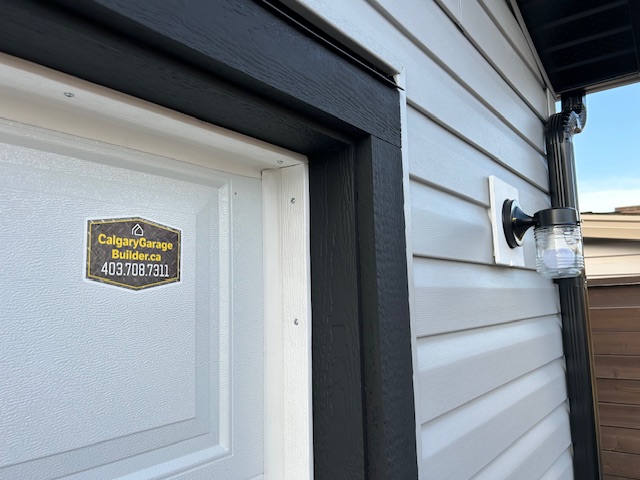 Calgary Garage Builders Sticker on Garage Door in Corepfield Calagry